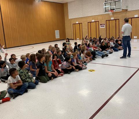 Mr. Cook talking to third grade students about the importance of always showing kindness and respect  to others.