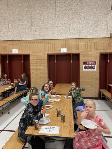 Rees students eating pizza and having fun at the pizza party.