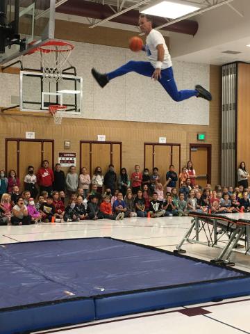 Man jumping to dunk basketball
