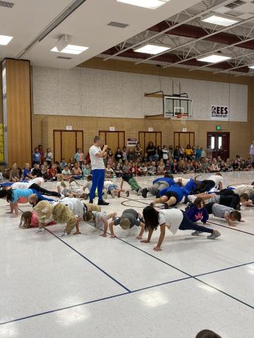 Students, Cosmo, and Dunk team doing push ups together