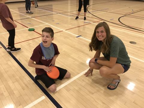 Boy and girl smiling in the gym at BYU