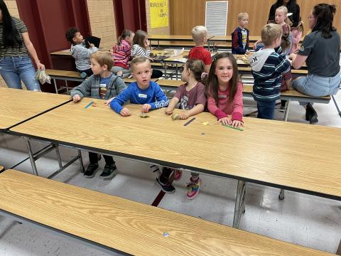Students sitting at a table during field day 