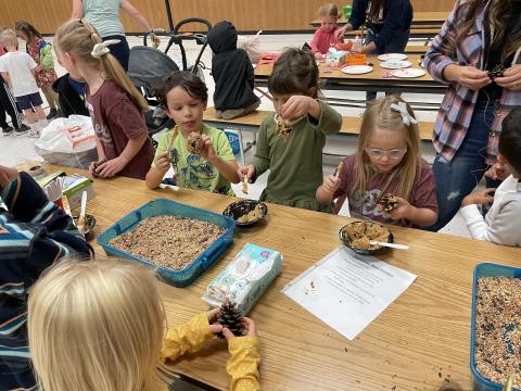 Kindergarten students making bird feeders