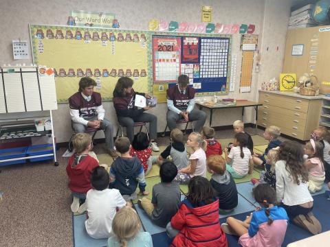 MMHS football players reading to Mrs. Searle's class