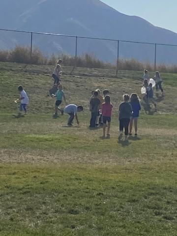 Students picking up trash on the hillside