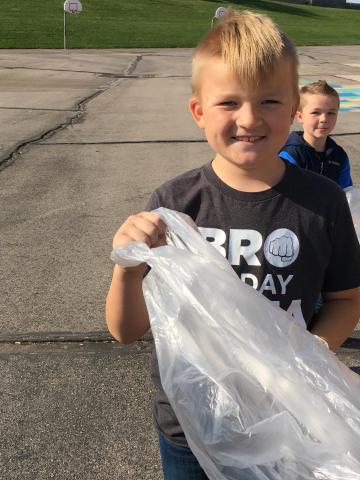 Boy holding trash bag