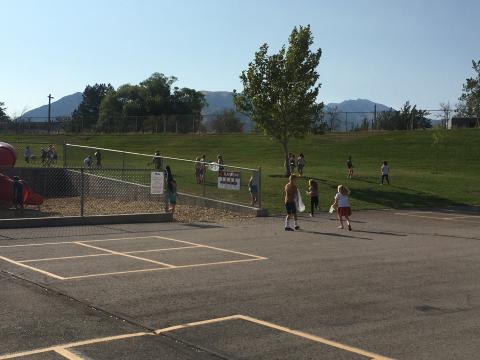 Students picking up trash around the playground