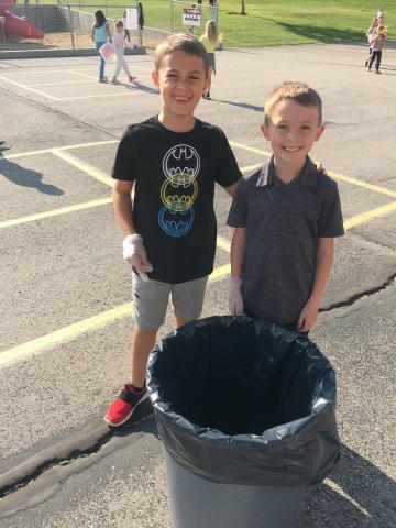 Two boys with garbage can
