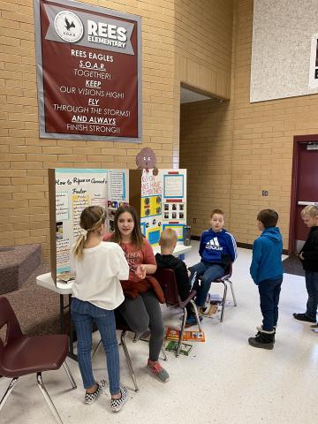 Boys and girls talking about their science fair projects
