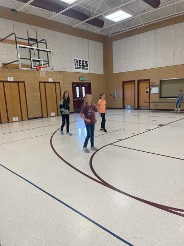Three 4th grade girls playing basketball