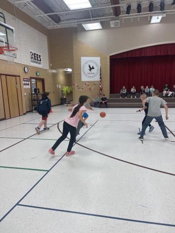 4th grade girl and boys playing basketball