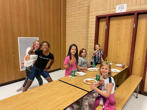 Rees students having fun as they enjoy some pizza and soda at the pizza party