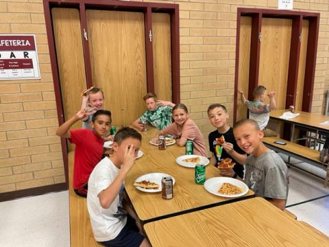 Rees students enjoying their pizza at the pizza party 