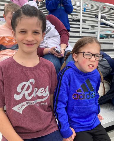 Two Rees girls smiling at the track meet