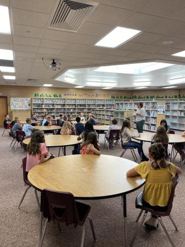 Fifth grade students in library with Mrs. Prescott