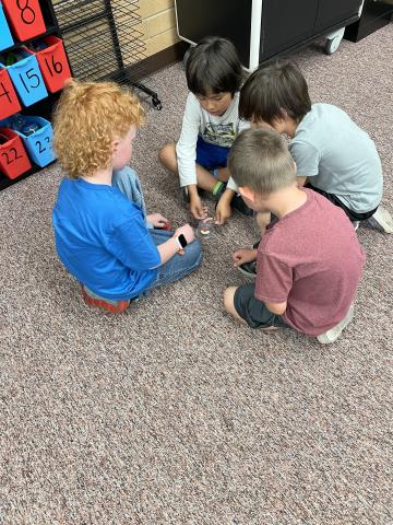 Second grade boys working to save Fred and worm. 