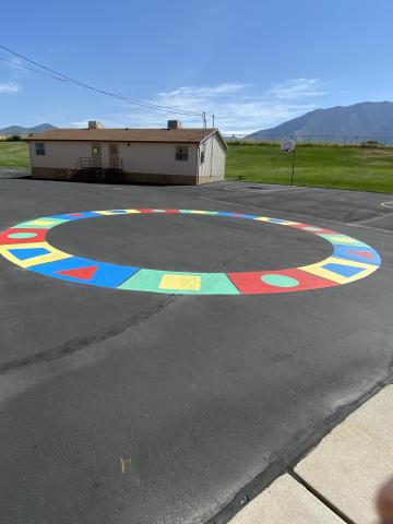 The outdoor shape circle painted on the blacktop for students to use
