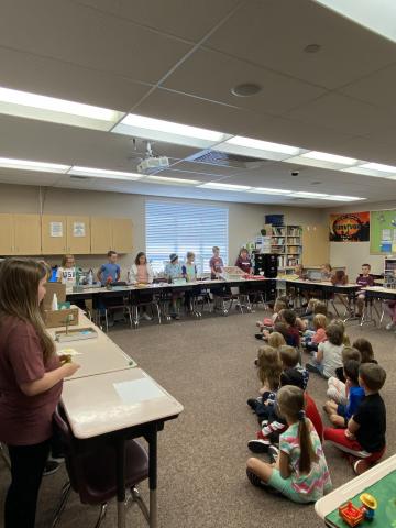 Rees students listening to 5th grade students share information about their states.