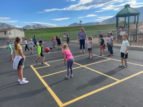 Students learning to play four square the right way