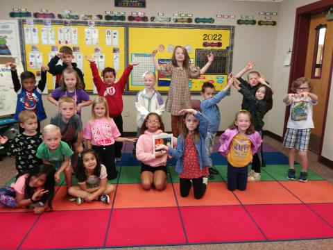 Mrs. Harvey's first grade class with the book The Little Old Lady Who Was Not Afraid of Anything.