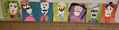 The Día de los Muertos finished art projects hanging in the hallway