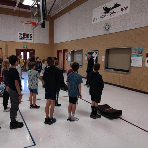 Rees 5th grade students standing in lines learning about karate