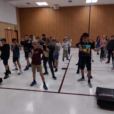 Rees 5th grade students learning karate moves