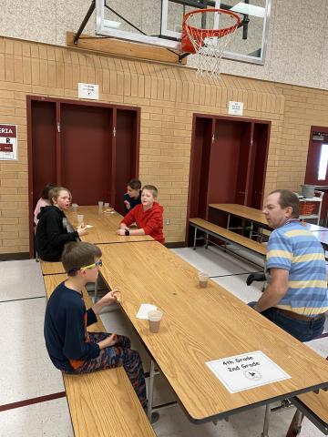 Mr. Cook visiting with some Rees boys as they eat their donuts. 