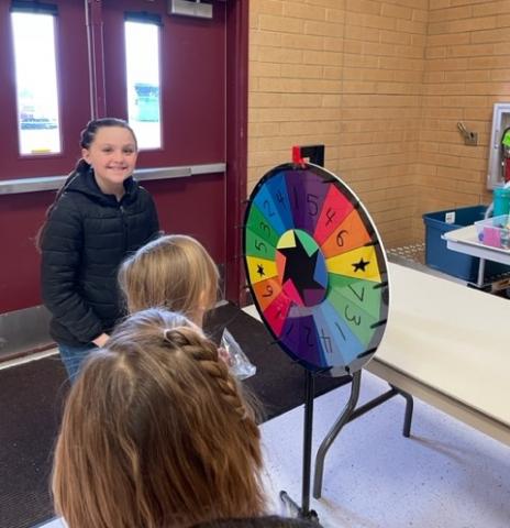 student council member with the students at the spinning wheel