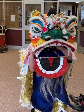 Dragon head performing for students. 