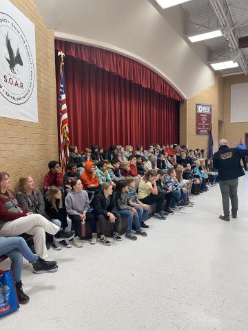 A MMHS band director talking with Rees 5th graders about playing in a band. 