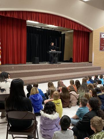Shaun Barrowes performing for Rees students during assembly 