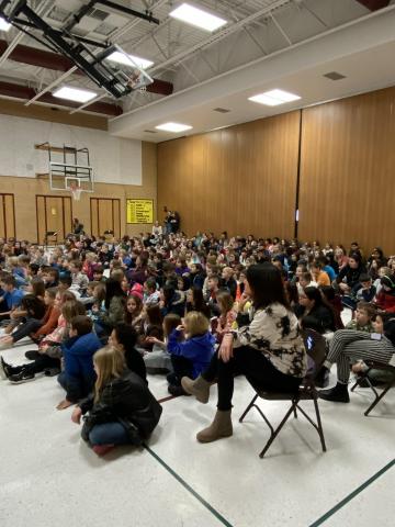 Rees 3rd-5th grade students listen to Shaun Barrowes perform in an assembly