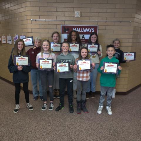 Rees 5th grade science fair winners holding their science achievement certificates. 