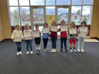 Second grade students who were awarded for being honest in October