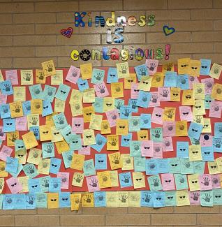 Kindness is contagious wall with notes from students to their peers. 