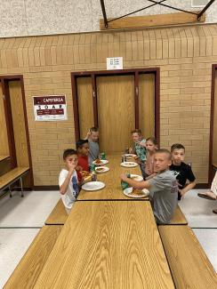 Rees boys eating their pizza and soda at the pizza party with Mr. Gull