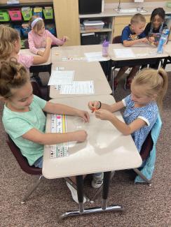 2nd grade students working together to save Fred the worm