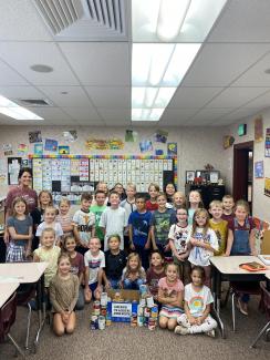 Mrs. Painter's third grade class with the food they will donate to a local foodbank. 
