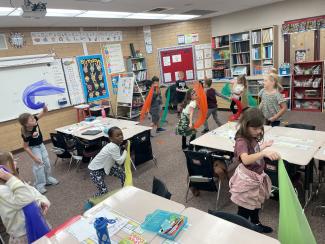 2nd grade boys and girls doing movement activity with scarves