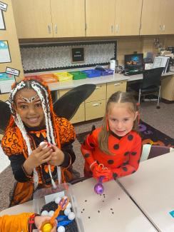 Two first grade girls in Mrs. Coley's class doing a Halloween activity