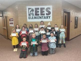 Group picture of December students of the month holding the certificates