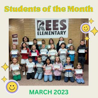 March Students of the month holding their certificates in front of the Rees Eagles Sign. 